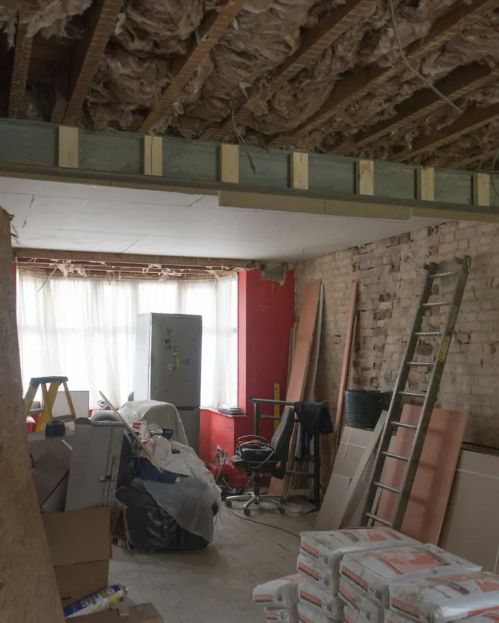 Room under renovation with the ceiling opened and a new steel beam fitted